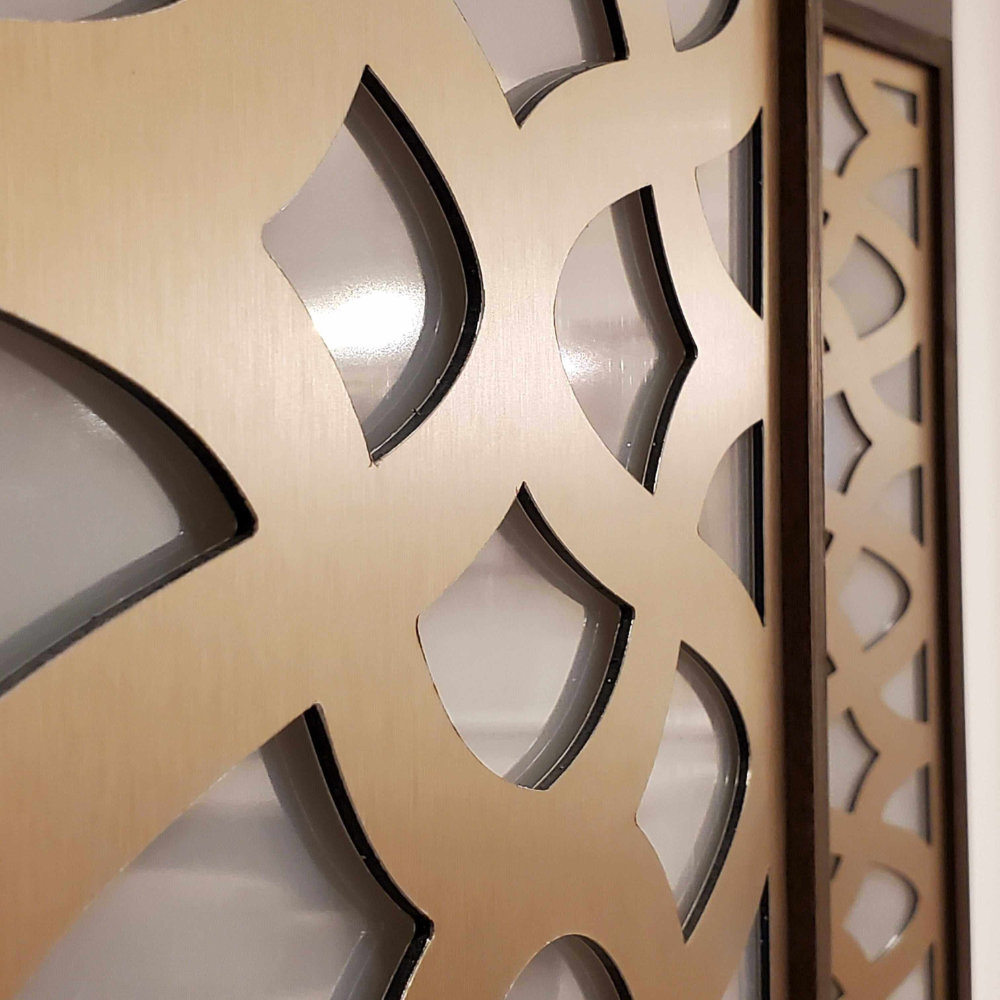 Decorative wall panel with geometric cut-out design on a white background